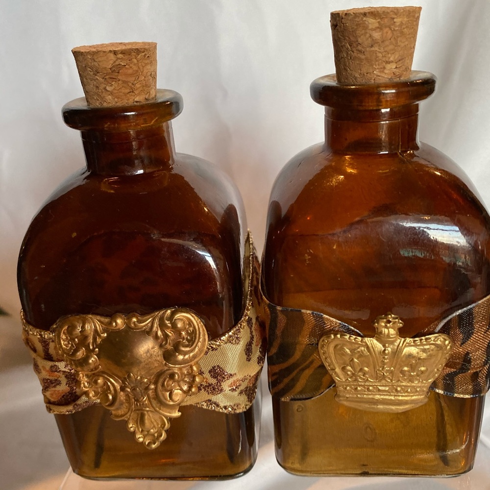 BROWN GLASS BOTTLES WITH RIBBON AND CORK.